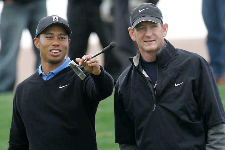Tiger Woods discusses his game with then-swing coach Hank Haney in 2007.