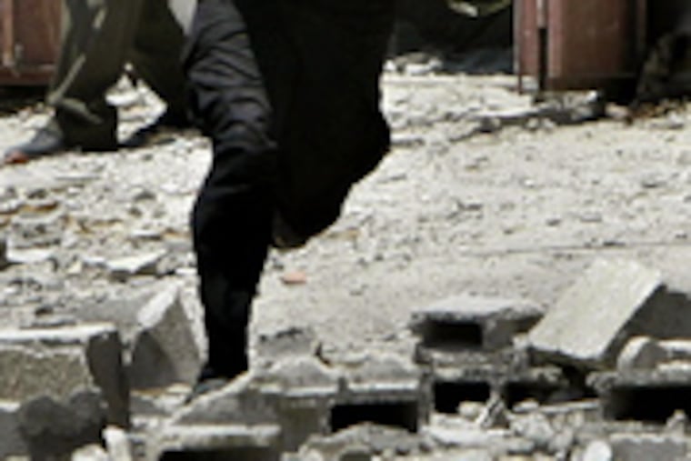 A Hamas fighter tries to avoid fire during clashes in Gaza City. The elected Palestinian leaders from Fatah and Hamas pleaded for calm, but power seemed to rest with the street militias.