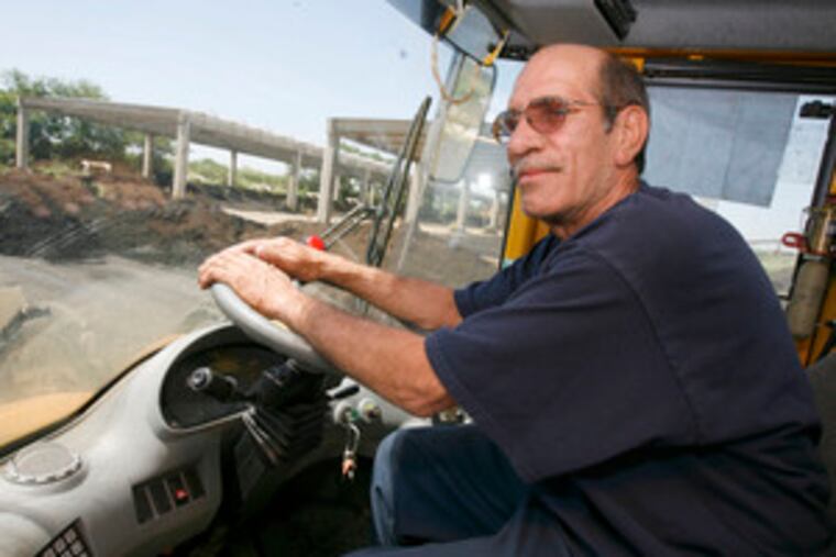 Longtime Water Department employee Mike Impagliazzo operates a front-end loader at the treatment plant. His union opposes privatization.