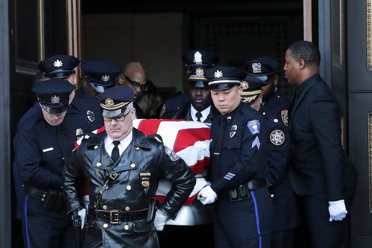 The casket of Temple University Police Officer Christopher Fitzgerald is carried outside of the Cathedral Basilica of Ss. Peter and Paul following his funeral services in Center City on Friday. In 2021, more officers were killed on duty than at any time in the last two decades.