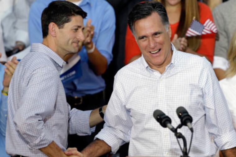 Republican presidential candidate Mitt Romney, right, is introduced by vice presidential running mate Rep. Paul Ryan, R-Wis., during a welcome home rally on Aug. 12, 2012, in Waukesha, Wis. (AP Photo/Jeffrey Phelps)