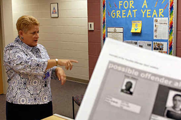 Spring-Ford superintendent Marsha Hurda talks to visiting parents as a mock sex-offender alert is held up by a school receptionist. (Tom Gralish / Staff)