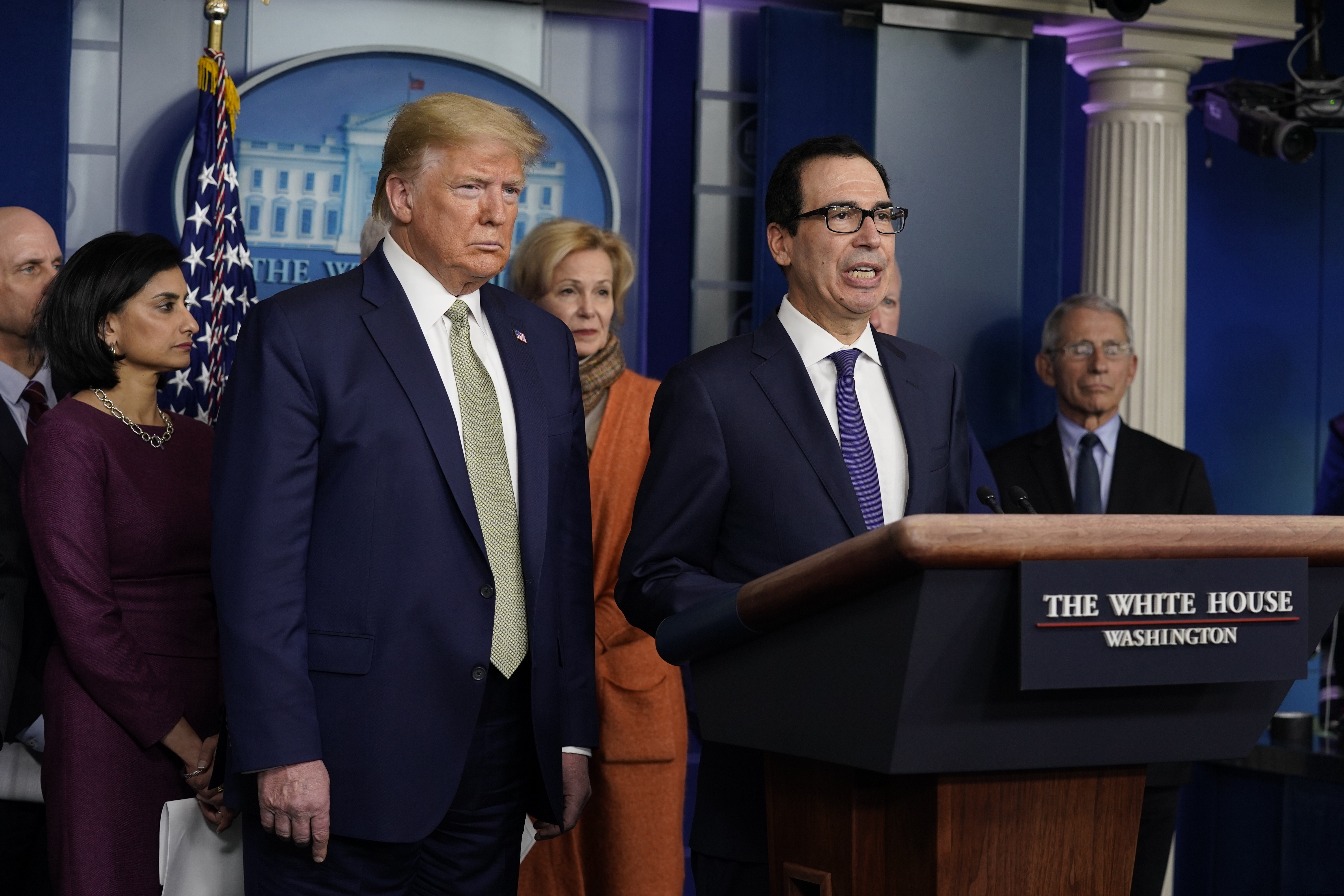 Treasury Secretary Steven Mnuchin speaks during a press briefing with the coronavirus task force, at the White House, Tuesday, March 17, 2020, in Washington, as President Donald Trump looks on.