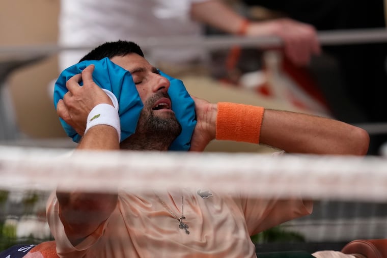 Novak Djokovic of Serbia cools himself during a break in Friday's third-round match against Joao Fonseca of Brazil at the French Open.