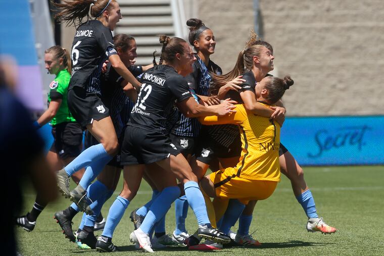 Sky Blue FC goalkeeper Kailen Sheridan gets mobbed in celebration after making the game-winning save.