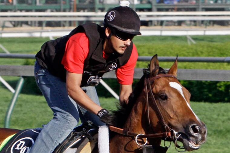 Exercise rider Jonny Garcia rides Kentucky Derby hopeful Goldencents for a workout at Churchill Downs Wednesday, May 1, 2013, in Louisville, Ky. (Garry Jones/AP)
