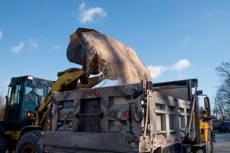 Front end loader operator David Herzog dumps road salt into a truck bed at the Newtown box. With the mild winter so far, PennDot hasn't had to put much salt down onto the roads, saving taxpayers money.