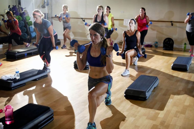 Christina Breeding works hard during a high-intensity interval training class on July 22, 2013, in Lexington, Kentucky. High-intensity workouts are a national trend with the idea of fast-paced, short workouts which focus specifically on different muscles. (Mark Cornelison/Lexington Herald-Leader)