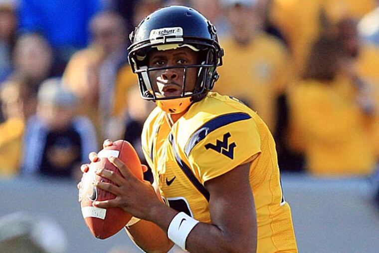 Chip Kelly and Howie Roseman did not have much to say about their private workout of West Virginia quarterback Geno Smith. (Christopher Jackson/AP file photo)