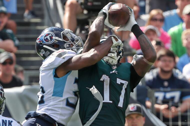 Eagle wide receiver Alshon Jeffery is able to catch the touchdown pass from Carson Wentz in the third quarter with Titan cornerback LeShaun Sims all in his face, to give the Eagels the lead in the game. Eagles lost to the Tennessee Titans at Nashville on Sunday September 30, 2018 26-23 in overtime. MICHAEL BRYANT / Staff Photographer