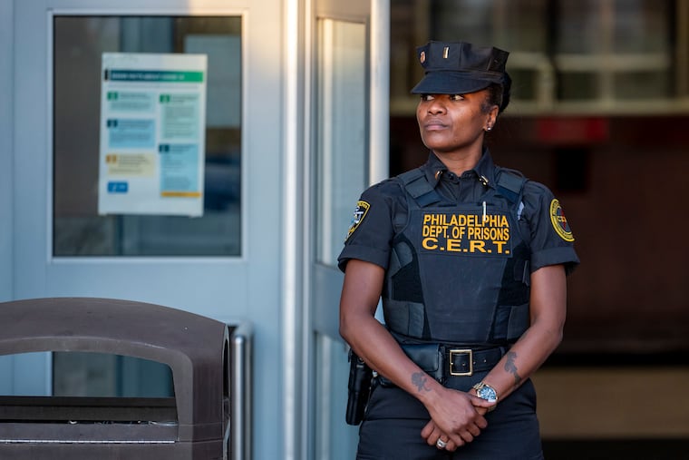 A Department of Prisons correctional emergency response team (CERT) officer stands by during a news conference outside the Philadelphia Industrial Correctional Center in May 2023. The city announced this week that it has reached an agreement to extend the contract with the correctional officers union.