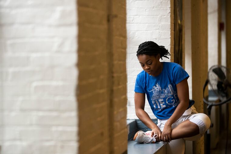 Kamali Thompson stretches before running drills at the Fencers Club in New York on Dec, 6. The Temple graduate was training for the 2020 Olympics.