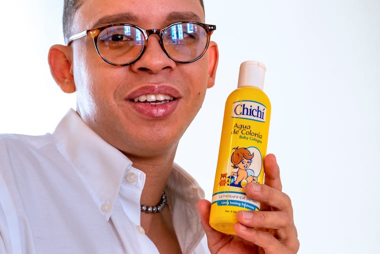 Jordano Pena-Sime displays the baby cologne he uses on himself. For Pena-Sime, who is from the Dominican Republic, the cologne reminds him of home and brings back childhood memories.