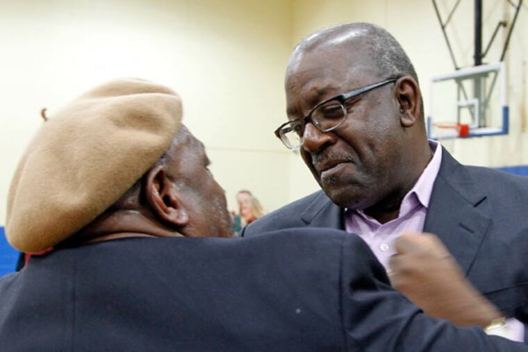 Kevin Washington (right) greets Boby Lewis, whom he grew up with.