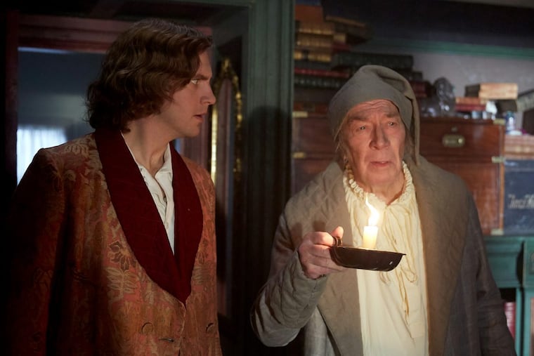 Dan Stevens (left) stars as Charles Dickens and Christopher Plummer plays Ebenezer Scrooge in “The Man Who Invented Christmas.”