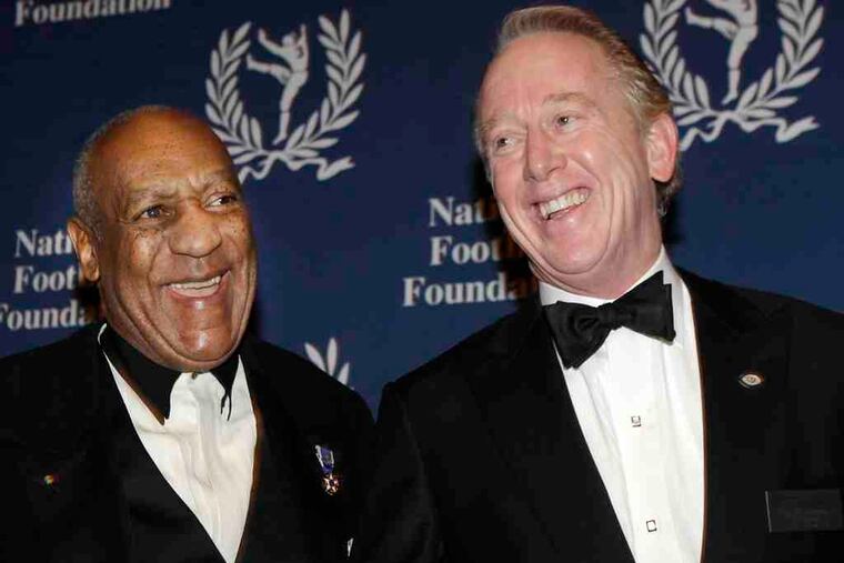 Comedian Bill Cosby (left) shares a light moment with National Football Foundation chairman Archie Manning at a cocktail reception before the College Football Hall of Fame awards dinner in New York on Tuesday. Cosby received the group's 2010 Gold Medal.