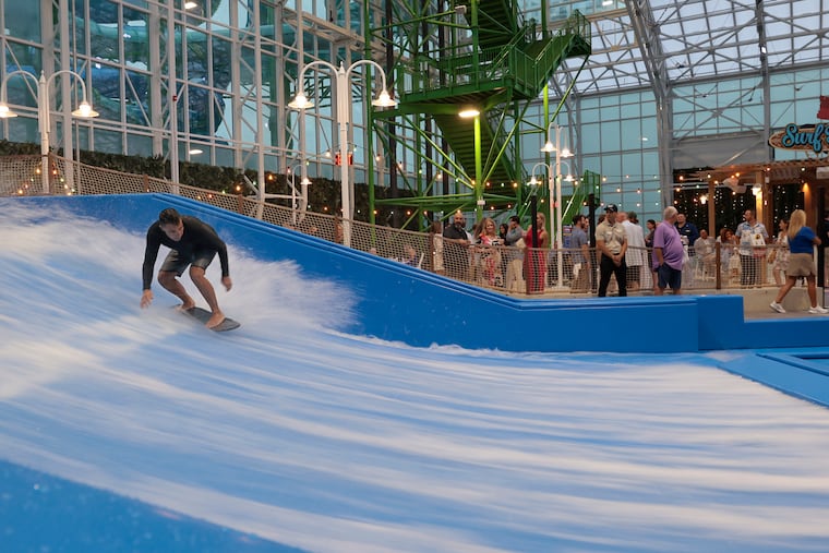 Mike Mrazek of Lacey Township surfs on the Wild Wave Flowrider during the Island Waterpark at Showboat preview event in Atlantic City in June.