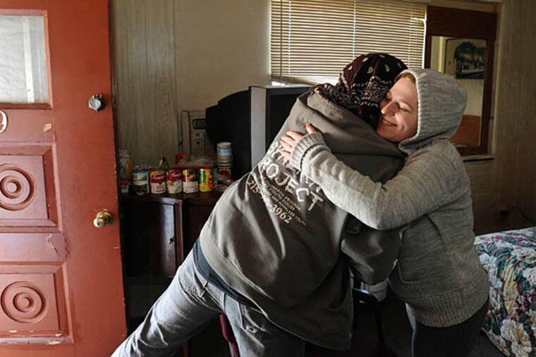 Jennifer Buchanan, 19, gives Shane Burroughs, director of Valley Youth House's Synergy Project, a hug as he leaves after visiting her and her friend Jake Winter in the Quakertown hotel room they are renting. February 14, 2013 ( RON TARVER / Staff Photographer )