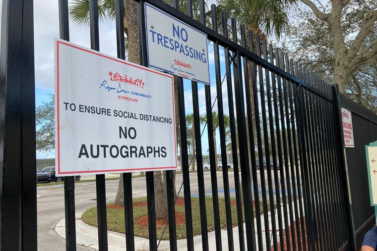 Signs are posted outside the gates to Roger Dean Stadium in Jupiter, Fla., where officials from Major League Baseball and the Players Association are holding meetings to negotiate a new collective bargaining agreement that would end a three-month lockout.