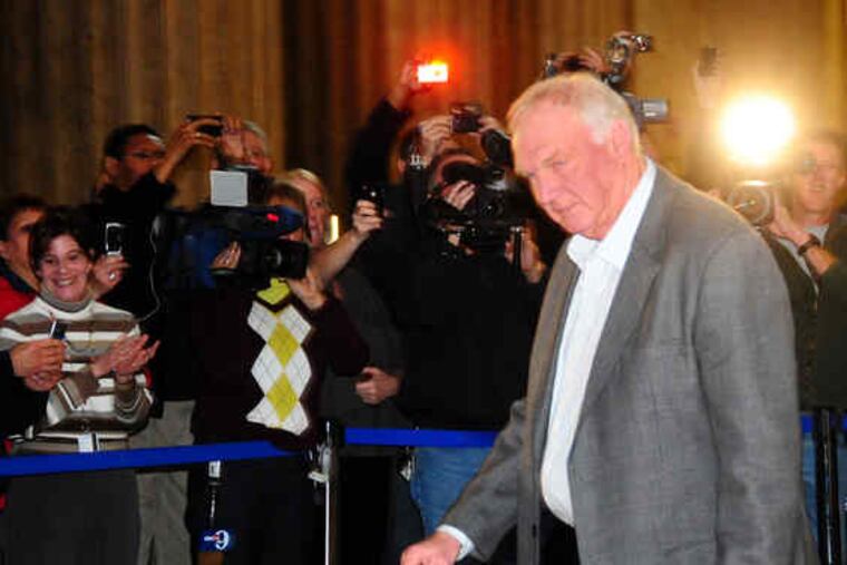 Phils manager Charlie Manuel is greeted with flashbulbs at the station.