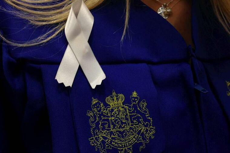 White ribbons are by graduates at Hofstra University's commencement in honor of Andrea Rebello.