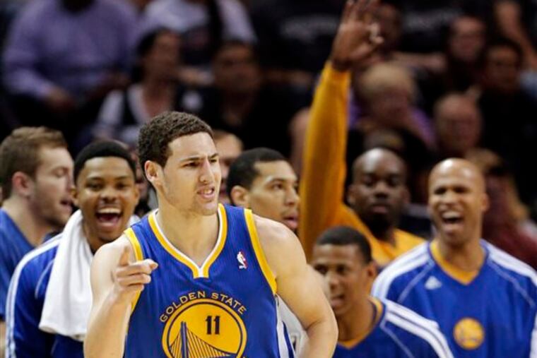 Golden State Warriors' Klay Thompson (11) celebrates a basket against the San Antonio Spurs during the first half in Game 2 of their Western Conference semifinal NBA basketball playoff series, Wednesday, May 8, 2013, in San Antonio. (AP Photo/Eric Gay)