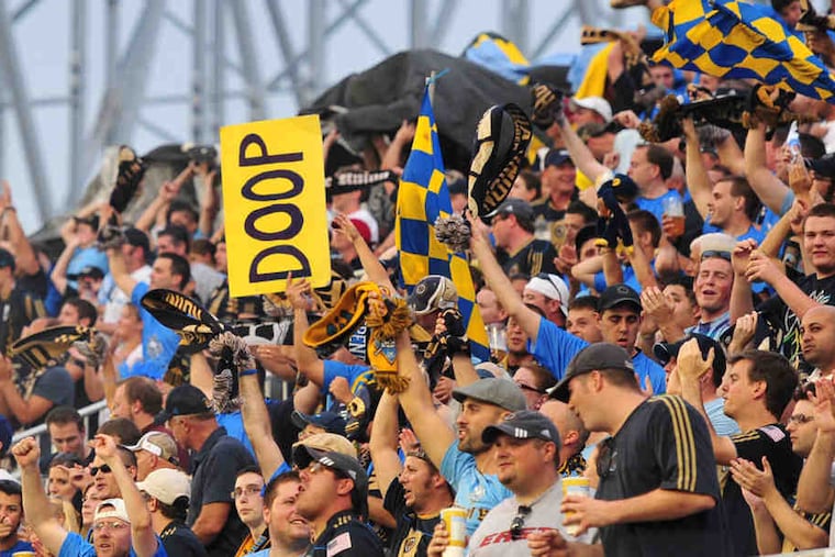Philadelphia Union fans with "doop" signs.