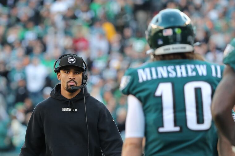 Philadelphia Eagles quarterback Jalen Hurts (left) walks the sideline as quarterback Gardner Minshew (right) returns to the bench in the third quarter. Eagles lose 20-10 to the Saints at Lincoln Financial Field on Sunday, Jan. 1, 2023, in Philadelphia, PA. Minshew played for the injured Hurts.
