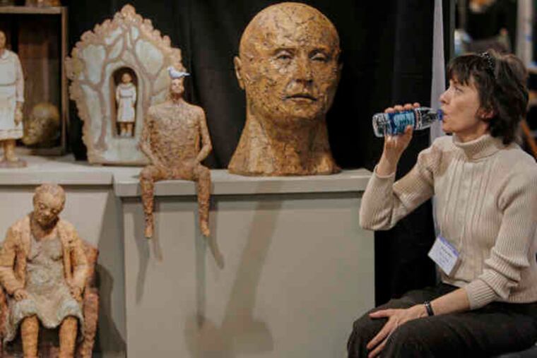 At the Buyers Market of American Craft, Marlene Miller from Washington, Ill., waits for customers to visit her Miller Clay Designs booth. The event, at the Convention Center, is one of the largest wholesale craft trade shows in the country, drawing about 1,200 artists from across the United States.