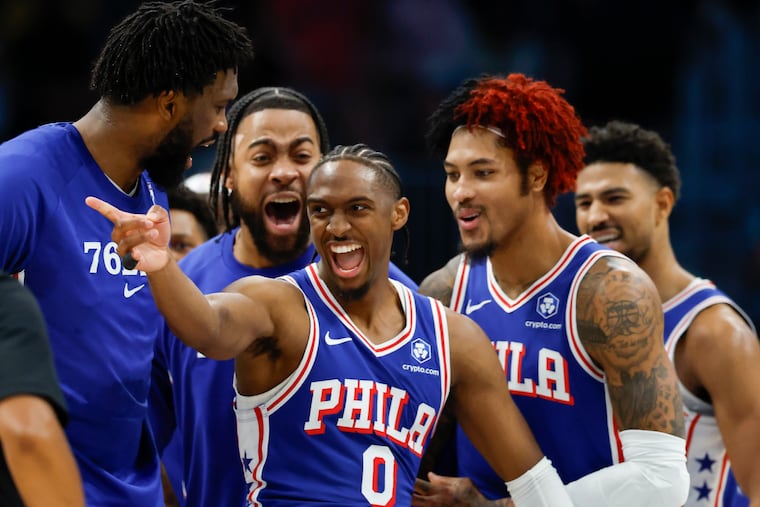 Sixers guard Tyrese Maxey celebrates with his teammates after dunking over Charlotte Hornets forward Miles Bridges.