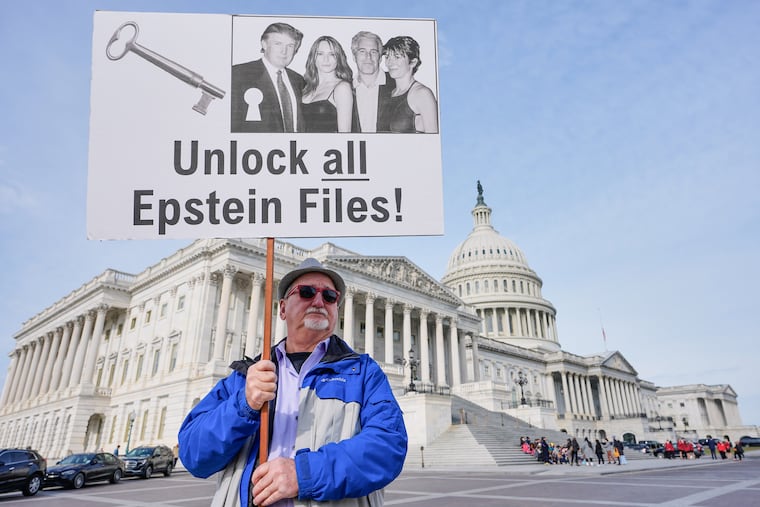 Gary Rush, of College Park, Md., holds a sign before a Nov. 18 news conference on the Epstein files in front of the Capitol.