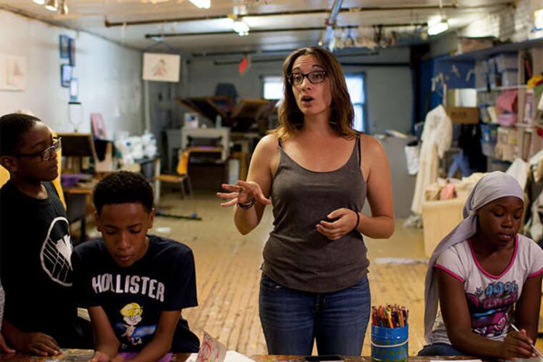 Aviva Kapust, executive director of the Village of Arts and Humanities with a group of art students.