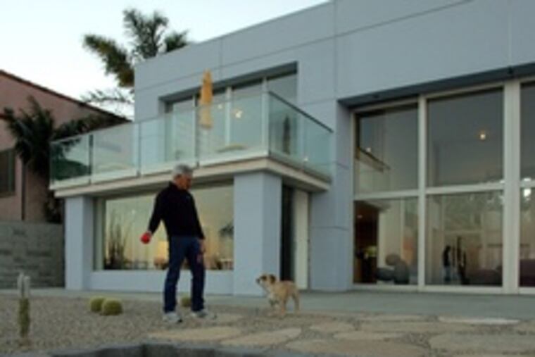 Artist Charles Arnoldi in his backyard, which once was grass, but has been redesigned as a minimalist sculpture installation.