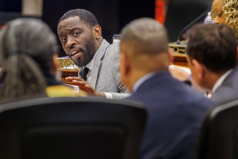 Councilmember Isaiah Thomas questions, from left, school board president Reginald Streater, school district Chief Operating Officer Oz Hill, and Superintendent Tony B. Watlington Sr., during a hearing about the school district's facilities plan on Tuesday.
