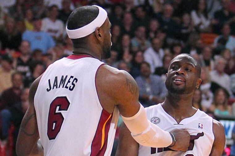 LeBron James (left) and Dwayne Wade celebrates after a play during the fourth quarter of an NBA basketball game at the American Airlines Arena in Miami on Friday, March 22, 2013. (David Santiago/AP El Nuevo Herald)