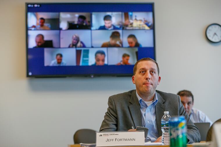 Vanguard manager Jeff Fortmann looks to the board at the front of the MBA class while 11 of his colleagues working in different parts of the world attend the class in Malvern over a live hook up. About 30 Vanguard employees are participating in a 27-month MBA program taught by Drexel professors.