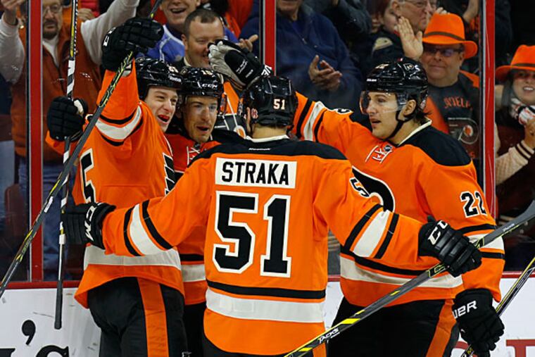 Flyers' Michael Del Zotto (second left) celebrates his first-period
goal with teammates Ryan White (left), Petr Straka and Luke Schenn
against the Toronto Maple Leafs on Saturday, January 31, 2015 in
Philadelphia. (Yong Kim/Staff Photographer)