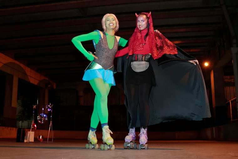 Tatiana Suuta, dressed as a space girl (left), and her sister Aija Suuta (right), dressed as a devil, during the sisters Halloween themed skating event at Front Street Skatepark, 1001 S Front St, in Phila., Pa. on October 22, 2022.