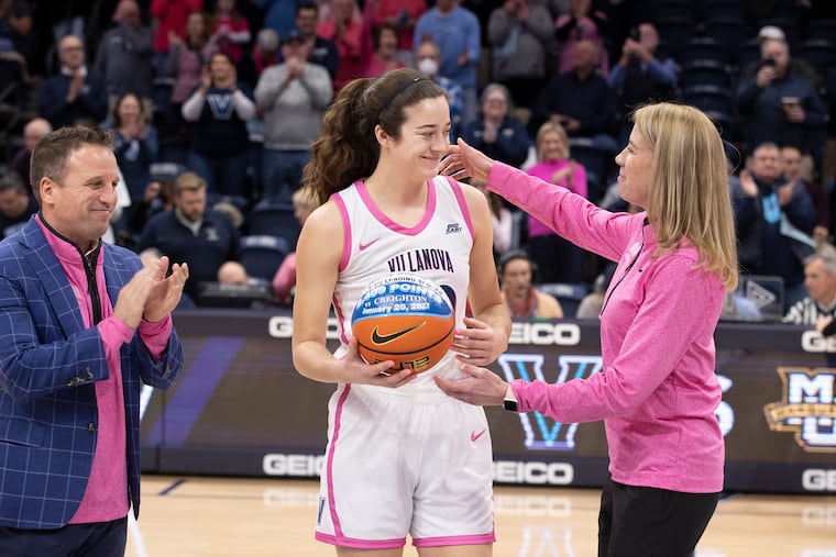 Maddy Siegrist (center) of Villanova was honored before the game against Marquette on Feb. 1 for breaking the school scoring record for both men and women at the Finneran Pavilion. On Saturday, Siegrist passed the Villanova single-game record (45), and the Big East single-game record (44) and became the Big East all-time leading scorer with 1,547 career points in conference play.