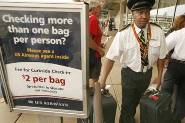 Airport skycaps make a base salary of $2.83 an hour. Tips used to bring an average of $150 extra a day - until airlines implemented a $2-per-checked-bag fee. (Charles Fox/Inquirer)