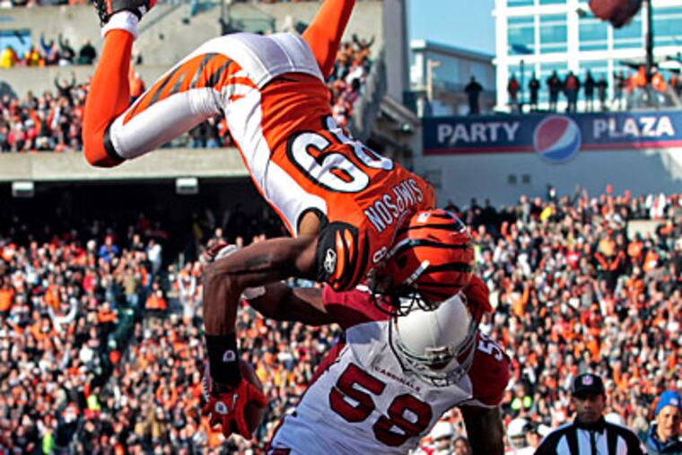 Bengals receiver Jerome Simpson flips over Cardinals line backer Daryl Washington for a touchdown. (Darron Cummings/AP Photo)