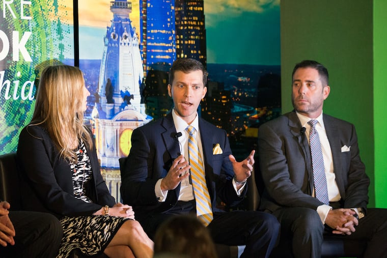 Steven H. Gartner (right), CBRE's managing director for retail services, listens as Vince Ranalli speaks at CBRE's annual forecast at the Logan Hotel in Philadelphia on Wednesday, Oct. 26, 2016.