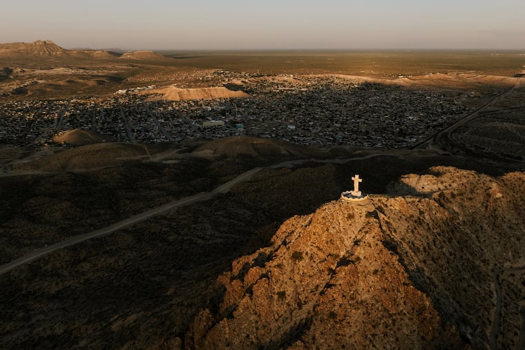 An aerial view of the 29-foot-tall limestone statue of Jesus on the cross atop Mount Cristo Rey in Sunland Park, N.M., June 7, 2026. The Trump administration’s Department of Homeland Security wants to build a border wall at the base of the mountain and popular pilgrimage destination, which rises near the juncture of the New Mexico, Texas and Mexico borders, and the small Catholic diocese that owns the land is trying to stop the plan.