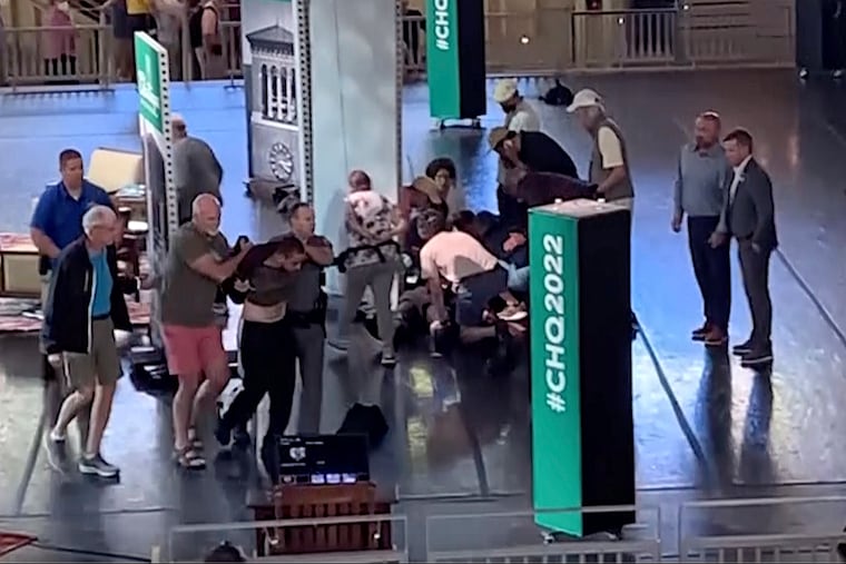 Hadi Matar, 24, of Fairview, N.J., at left, being escorted from the stage as people tend to author Salman Rushdie, center right, at the Chautauqua Institution, in Chautauqua, N.Y., on Friday.