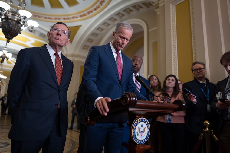 Senate Majority Leader John Thune (center), joined at left by Sen. John Barrasso (R., Wyo.), the GOP whip, speaks to reporters Tuesday at the Capitol in Washington.