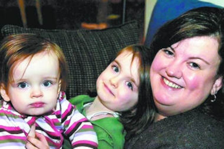 Attorney Heather Powell, with daughters Maeve (left) and Eleanor. Her husband cared for the girls before recently returning to work.