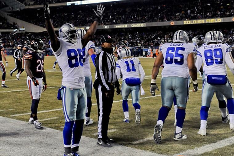 Dallas Cowboys wide receiver Dez Bryant (88) raises his arms after Dallas Cowboys wide receiver Cole Beasley (11) scores a touchdown in the second half of their game against the Chicago Bears at Soldier Field. (Matt Marton/USA TODAY Sports)