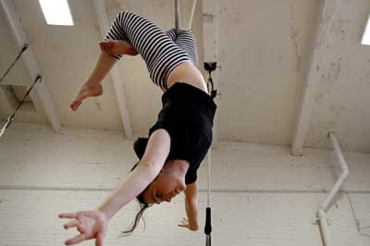 Agatha Koprowski, 26, of West Philadelphia, practices on the trapeze
at the Philadelphia School of Circus Arts. (David Maialetti / Staff Photographer)
