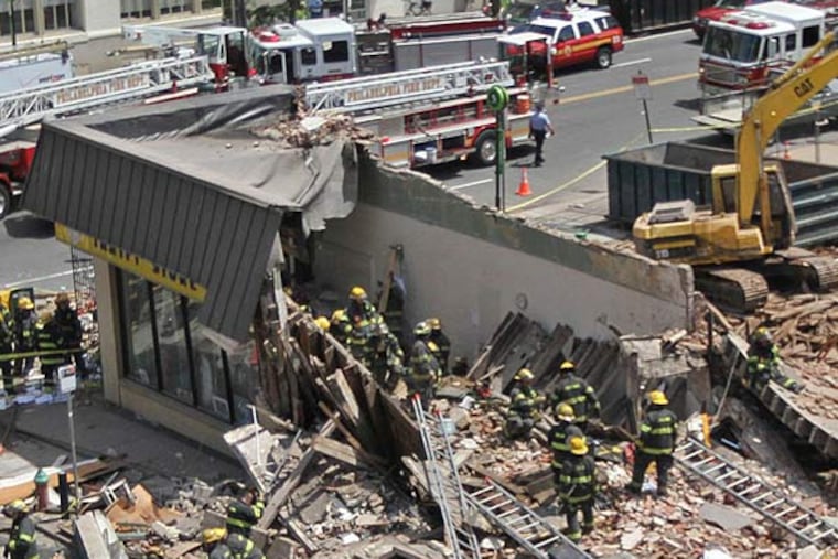The disaster scene at 22nd and Market, where six people died when a wall collapsed onto a thrift store June 5, 2013. A design for a memorial at the site won Philadelphia Art Commission approval this week. (MICHAEL BRYANT / Staff Photographer)