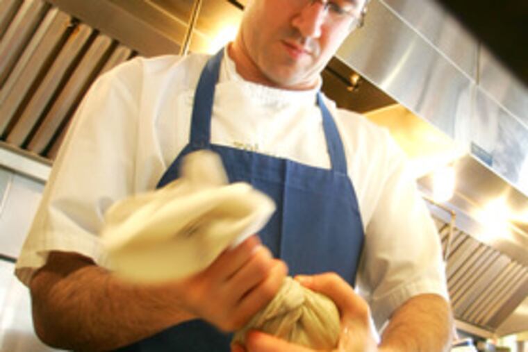 At Zahav, chef-owner Michael Solomonov squeezes moisture from grated potatoes.